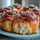 Fluffy orange rolls with fresh zest, baked until golden and topped with a sweet citrus glaze.  