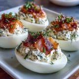 Smoked salmon deviled eggs garnished with everything bagel seasoning, chives, and dill—a perfect party appetizer.