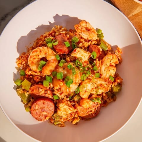 Fragrant jambalaya, richly spiced with andouille sausage and tender shrimp in a flavorful broth.