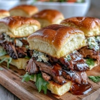 1. BBQ Baby Shower Brisket Sliders with smoky, tender brisket, tangy BBQ sauce, and crisp slaw on soft slider buns.  