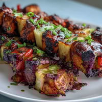 Grilled pineapple chicken skewers with juicy chicken and caramelized pineapple, perfect for summer barbecues and cookouts.